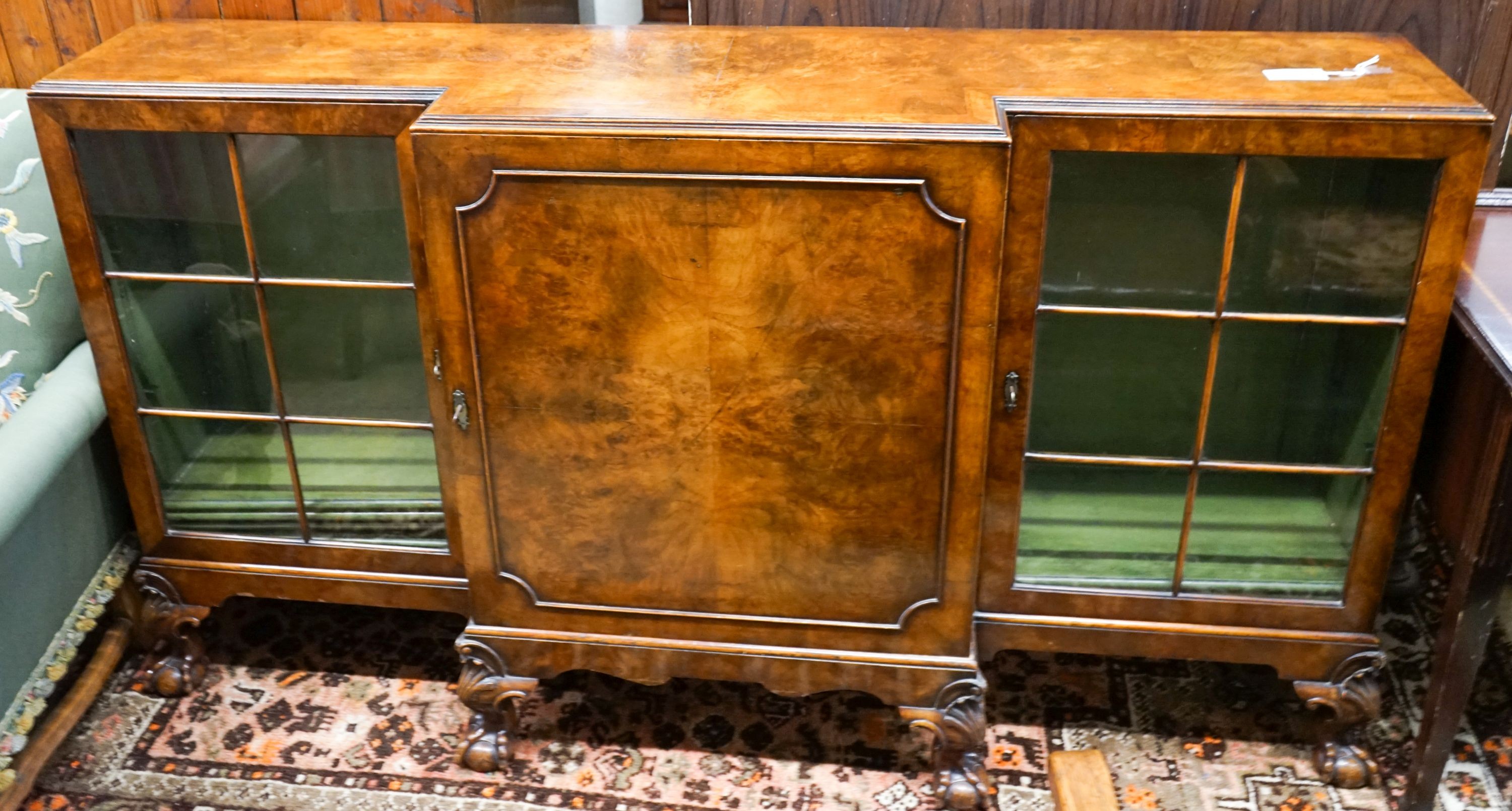 A Queen Anne revival figured walnut breakfront bookcase